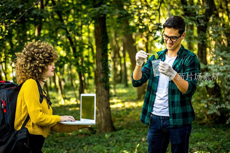 Scientist ecologist in the forest take samples of plants.